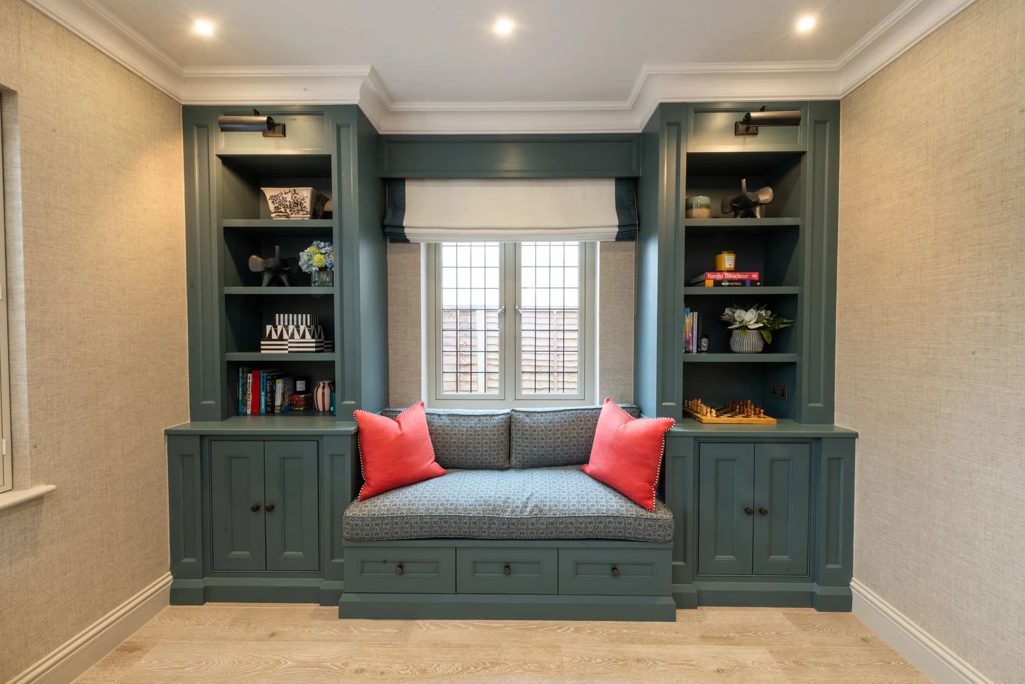Green in-frame study with a window seat between bookcases