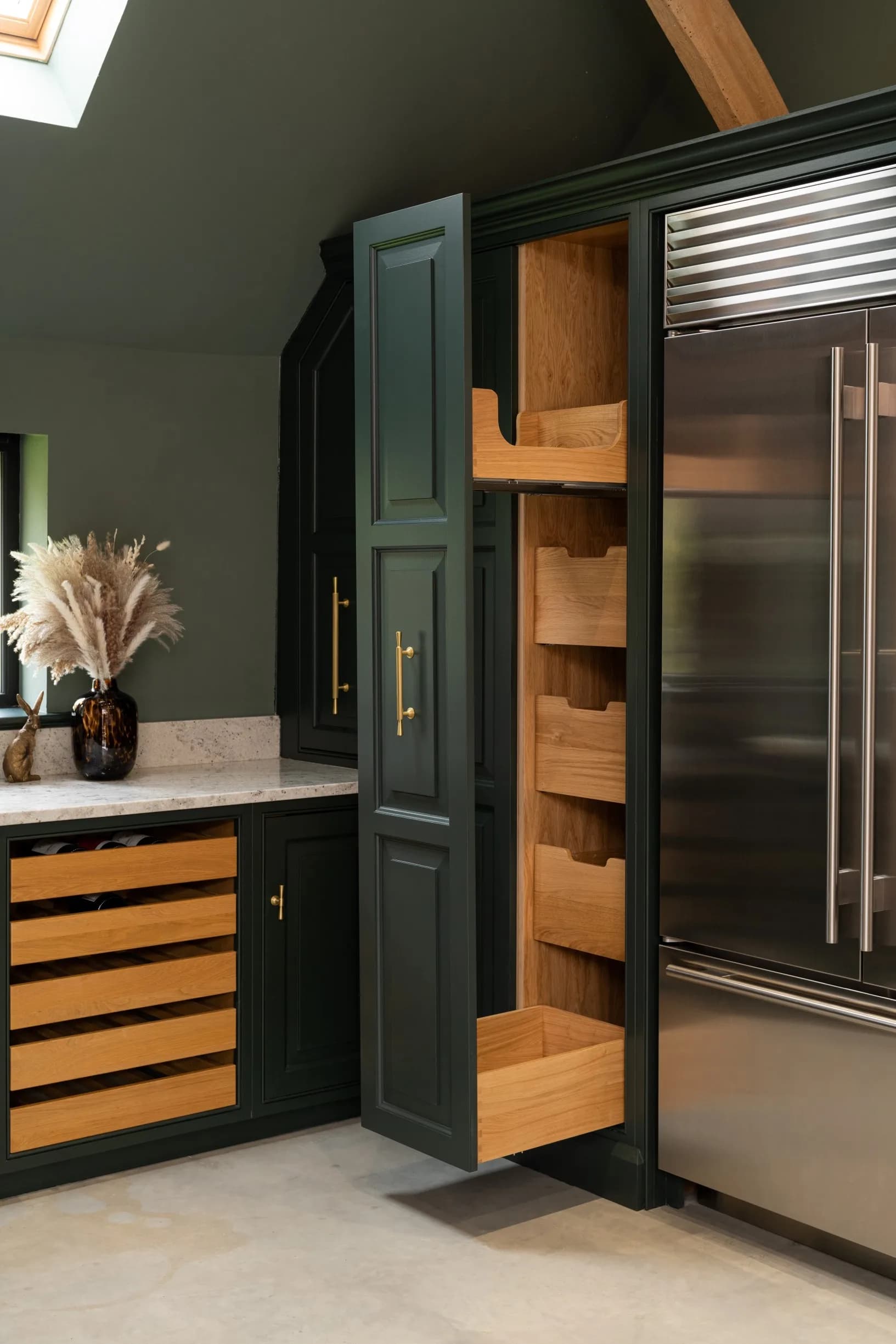 Sub-Zero refrigeration beside a hand-painted larder with oak pull-out drawers