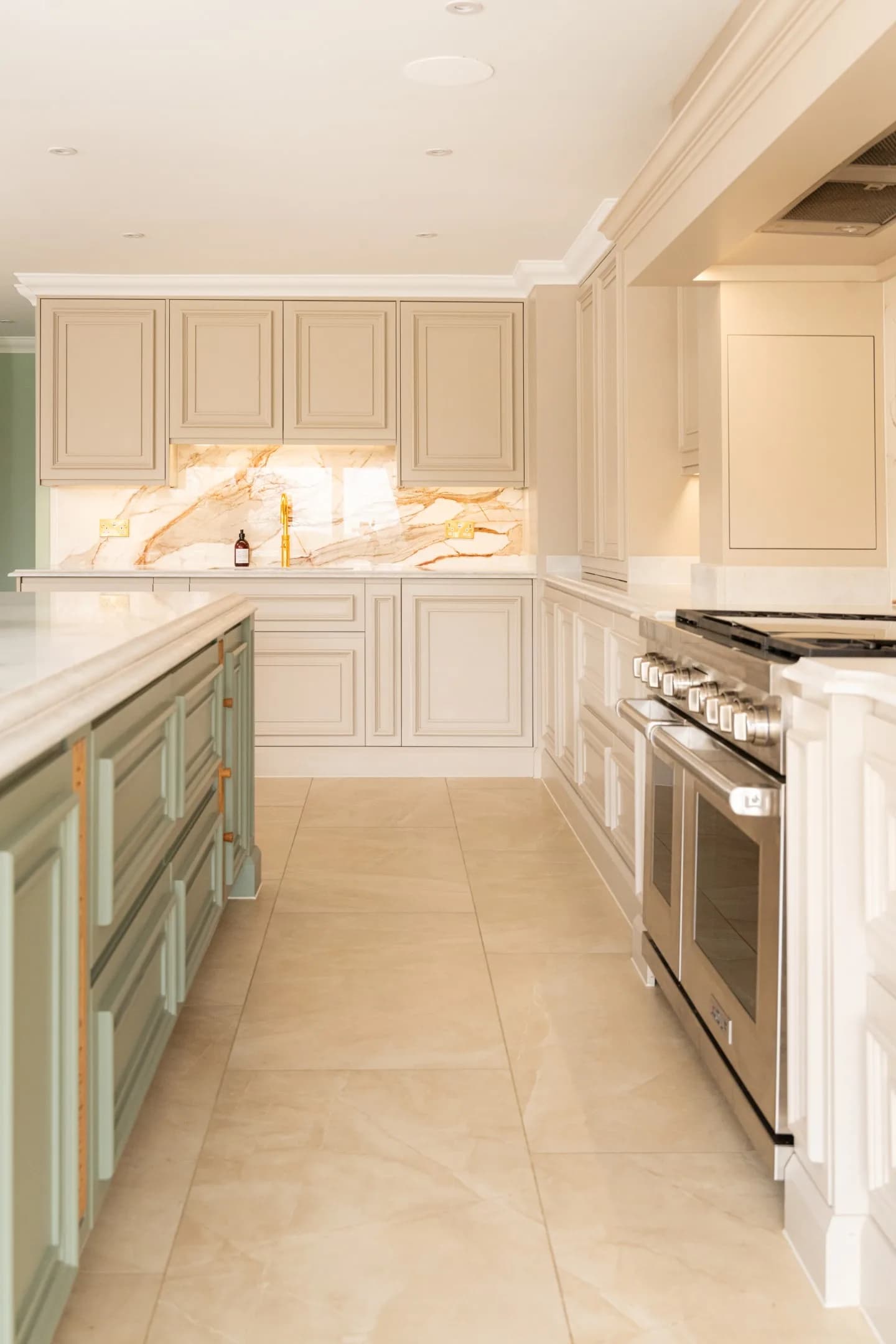 Hand-painted Mapesbury shaker kitchen with a sage green island and range cooker
