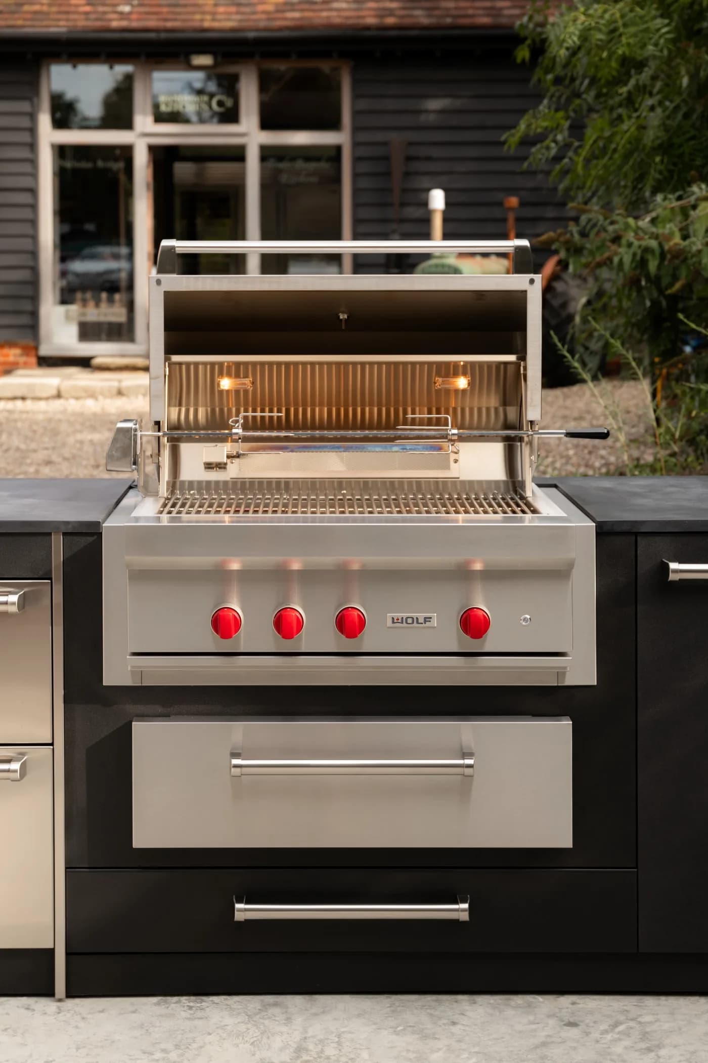 Outdoor kitchen with a Wolf gas grill and warming drawer